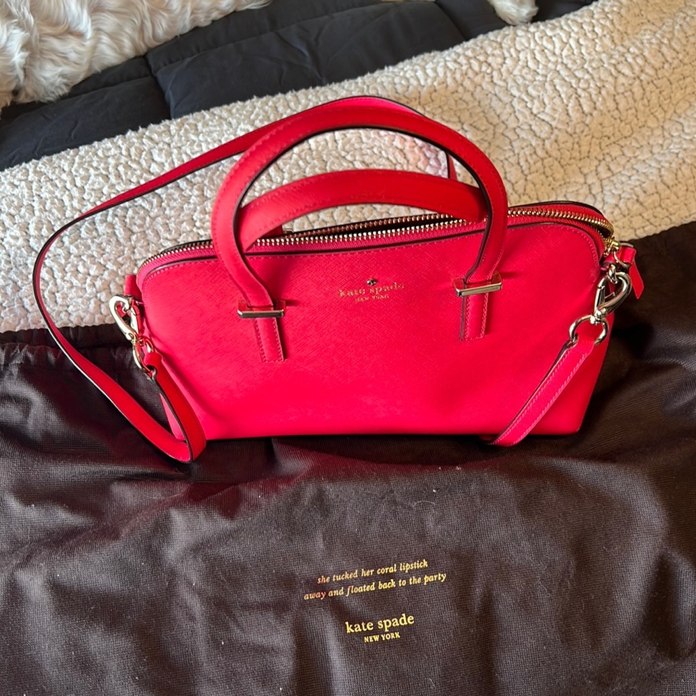 Kate Spade purse with cross body strap and handles. Hot pink color